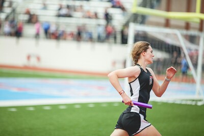 A woman running in a track meet